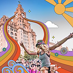 Someone at a festival with the Royal Liver Building in the background.