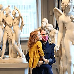 A lady and daughter next to sculptures in Walker Art Gallery