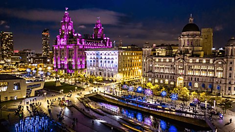 Liverpool Waterfront at night, with the Royal Liver Building bathed in pink light