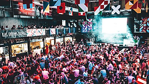 Crowds of people watching football at BoxPArk