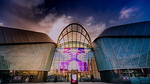 An exterior view of ACC Liverpool with a cloudy sky.