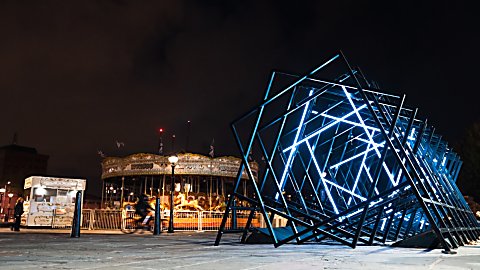 An art installation made of diffrent squares in a line lit up blue.
