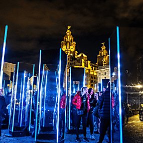 Mirrored monoliths on Liverpool's Pier Head in the dark. The Royal Liver Building can be seen in the background