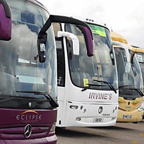 Three coaches parked beside one another with two logos on the front of each coach.