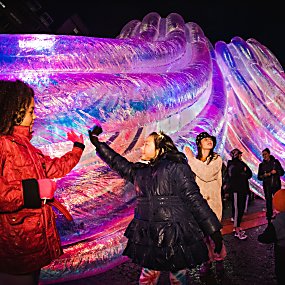 A large inflatable sculpture with children stood inside and interacting with it
