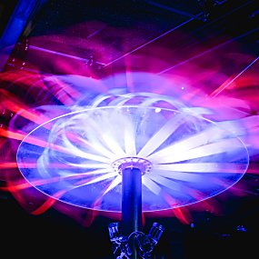 A mushroom shaped installations with ribbon strings and a blue pole.