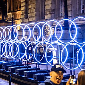 Concentric rings on a horizontal beam spinning around lit in blue/white led lights.