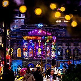 The exterior of Liverpool Town Hall with neon lights decorating it