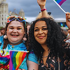 Two girls with pride flags on Liverpool Pier Head