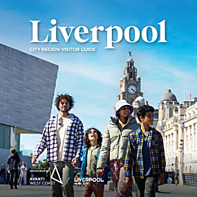A family of four walking towards the Royal Albert Dock while looking out towards Liverpool.