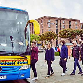 People getting onto the Magical Mystery Tour bus