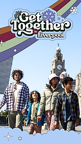 A family of four with two adults and two children outside of the Royal Liver Building in Liverpool.