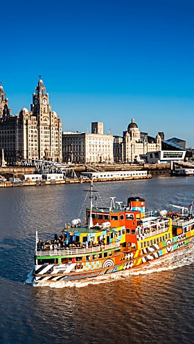 A Mersey Ferry on the River Mersey with the Three graces in the background.