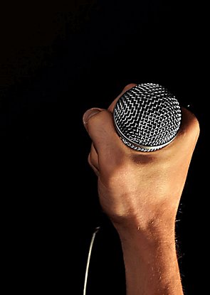 A microphone being held in the dark