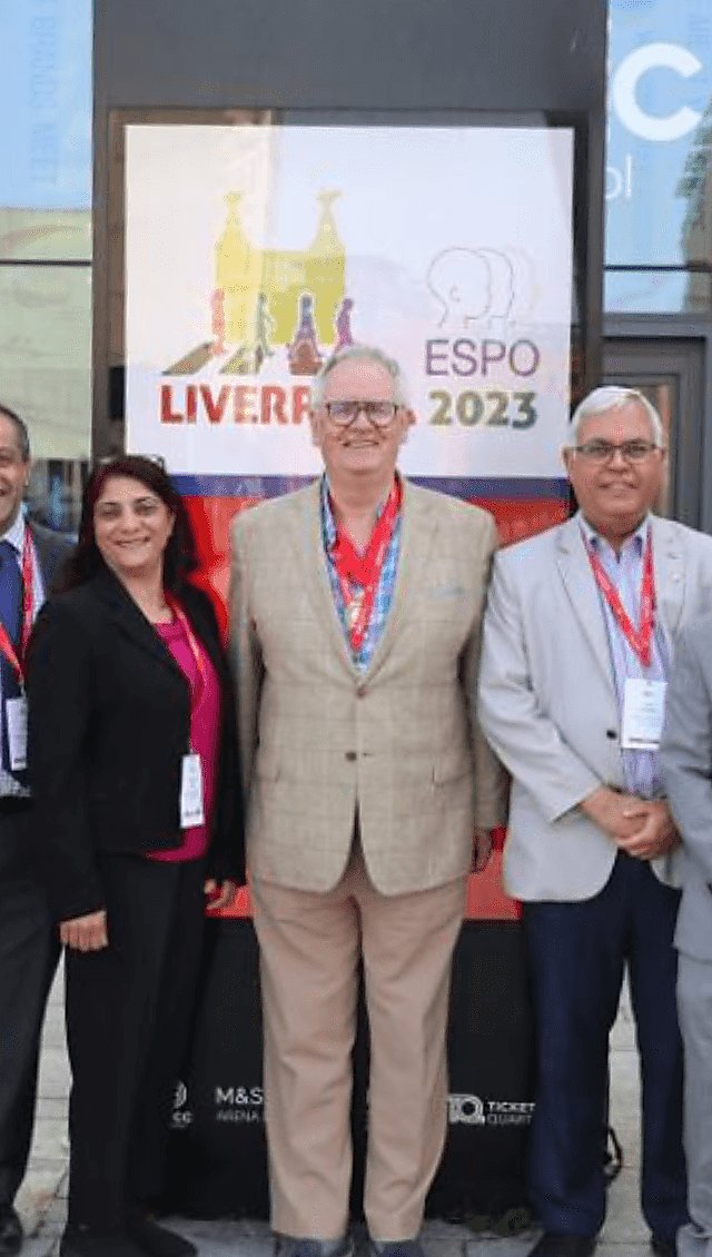 Two men and a lady standing outside a sign with ESPO 2023 on it