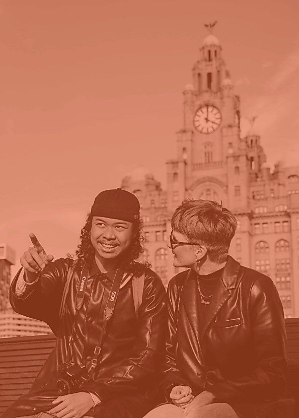 Two people looking towards the Mersey with a Liver bird in the background.