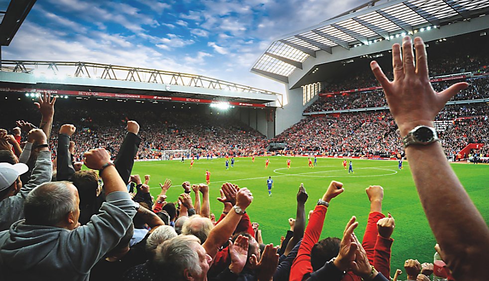 People wathing a football match at Anfield