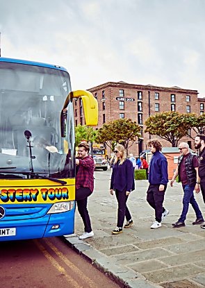 People getting onto the Magical Mystery Tour bus