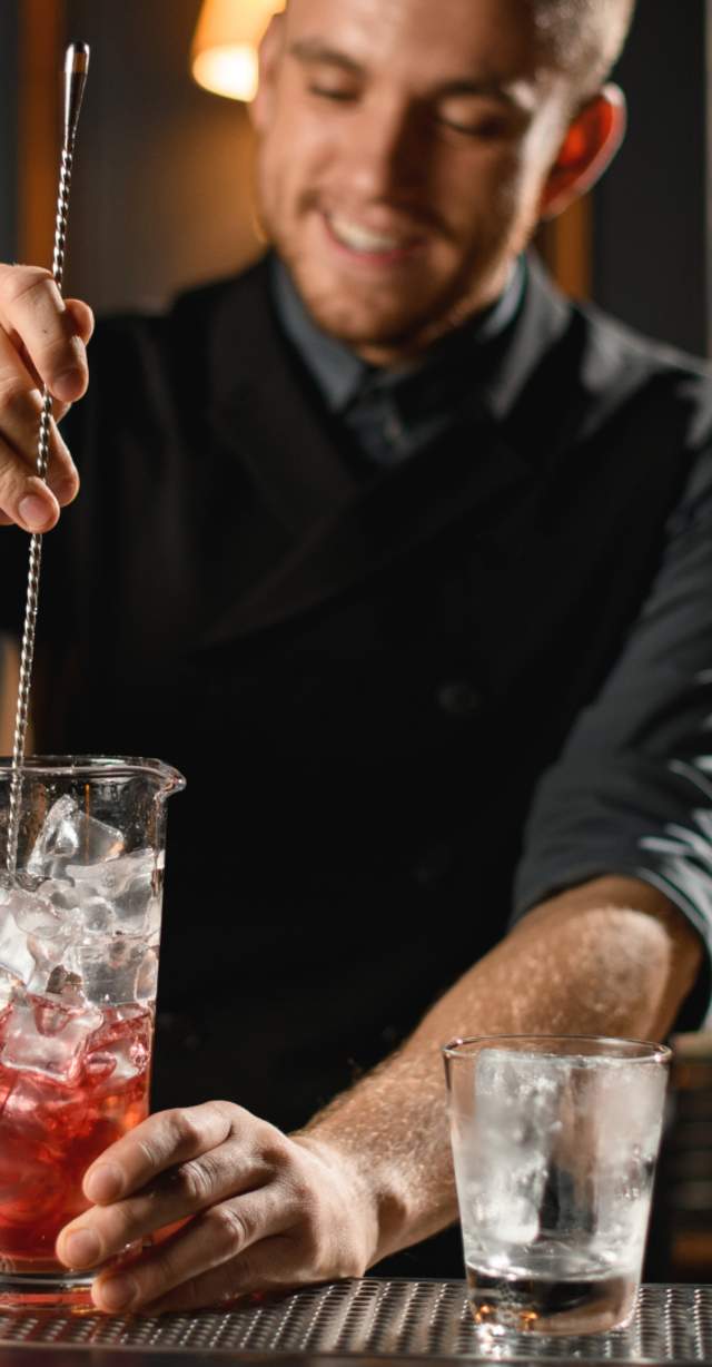 Male bartender mixing a drink