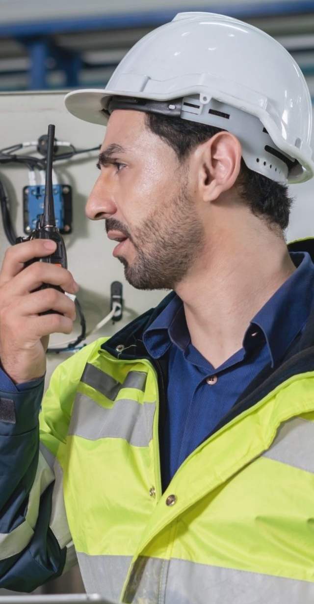Building Maintenance Engineer talking on radio