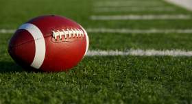 A football laying on a field.