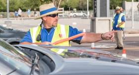 a parking assistant directing traffic for an event at the Buddy Holly Hall in Lubbock