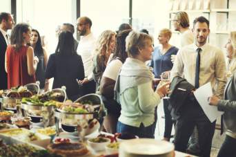 A group of people conversing in a hall.