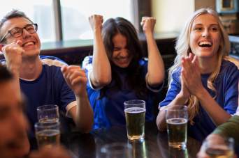 A group of friends celebrating around a table.