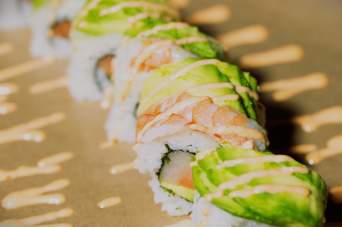Savor the creamy richness of avocado perfectly paired with our fresh sushi, adding a delightful twist to every bite