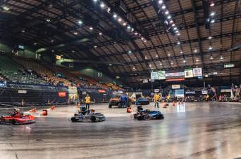 Children racing go karts around the arena bowl
