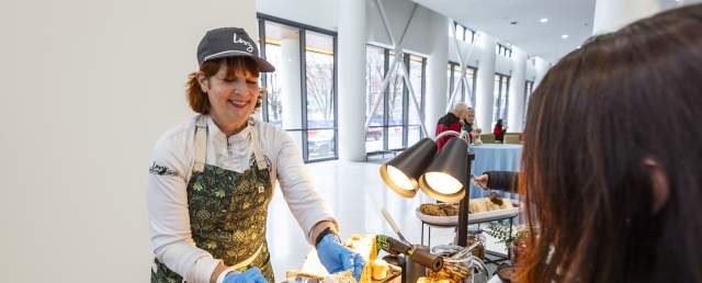 A chef prepares a toasted s’more for a guest at an interactive dessert station inside First Financial Center.
