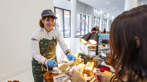 A chef prepares a toasted s’more for a guest at an interactive dessert station inside First Financial Center.