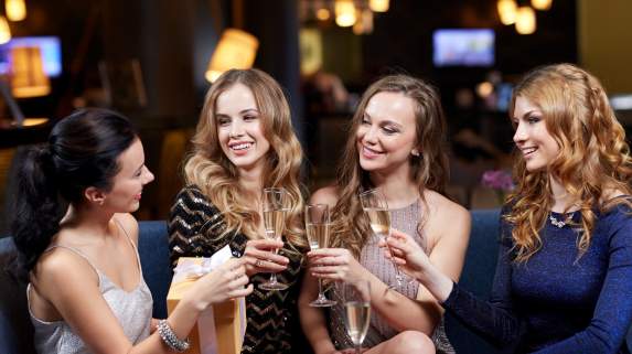 Group of women raising champagne flutes