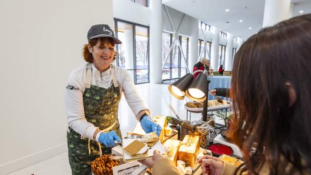 A chef prepares a toasted s’more for a guest at an interactive dessert station inside First Financial Center.