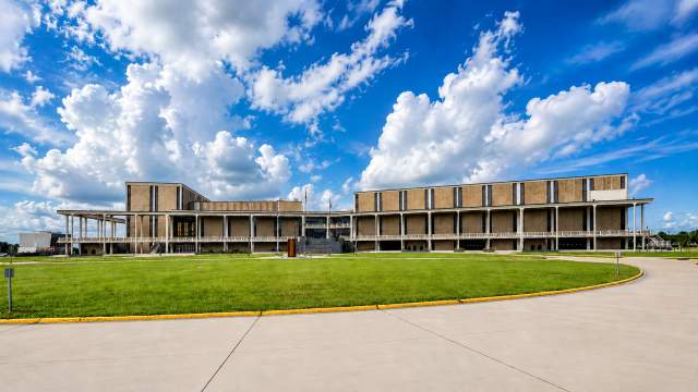 Modern civic building under dramatic skies