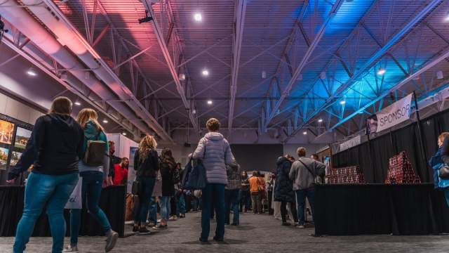 Attendees walking to vendor booths during a bridal expo