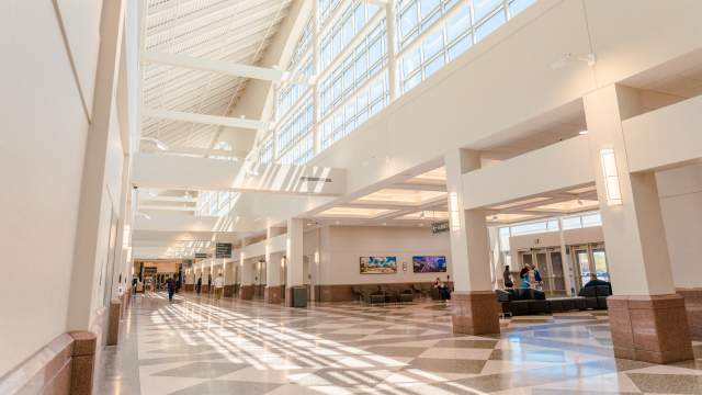 empty concourse hallway with large windows and natural lighting