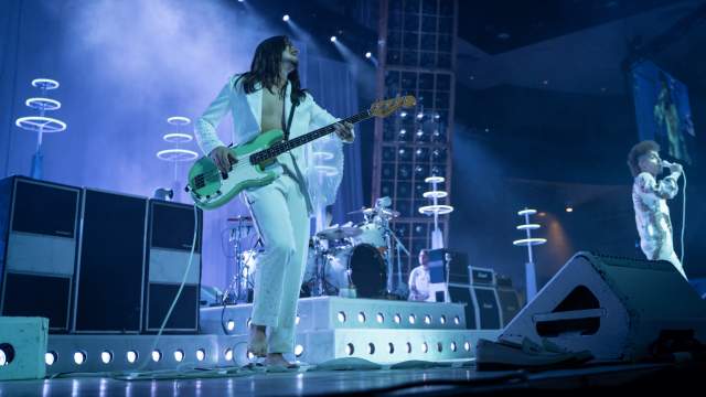 image of someone playing guitar on a stage with bright lights
