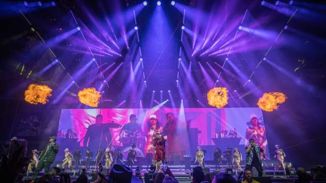 image of a concert stage with fire and lights