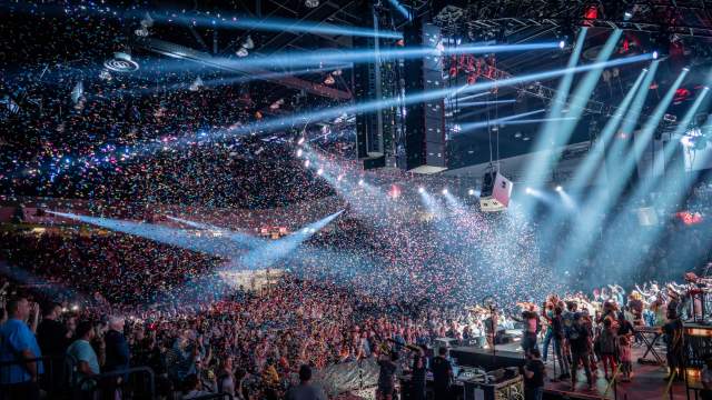 image of a concert in an arena with lights
