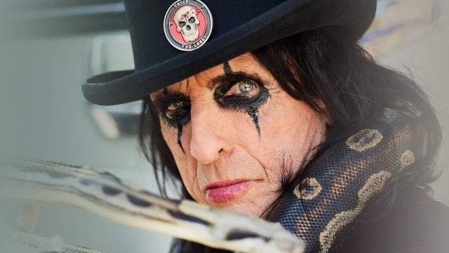 Alice Cooper with a snake wrapped around his neck