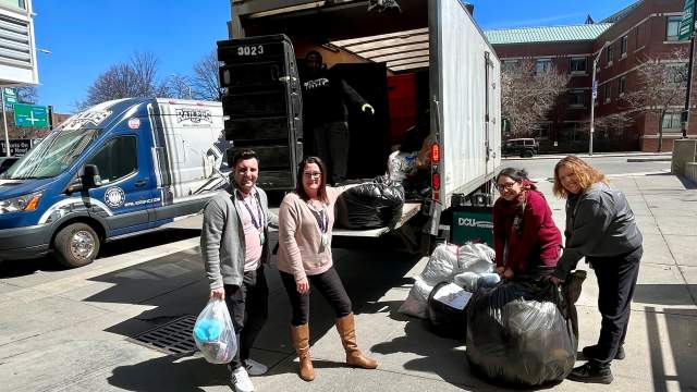DCU Center employees loading apparel donations into the Helpsy truck.