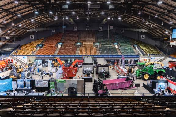 Overhead view of farm equipment placed in the arena for a farm expo