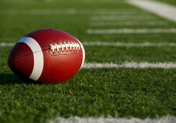A football laying on a field.