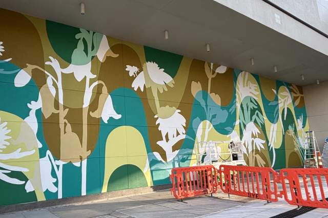 Colorful floral mural on an outside wall by Atalie Gagnet