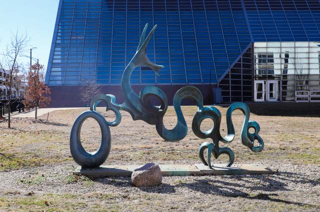Cedric the Dragon sculpture by Nita Sunderland - Metal sculpture in outdoor plaza