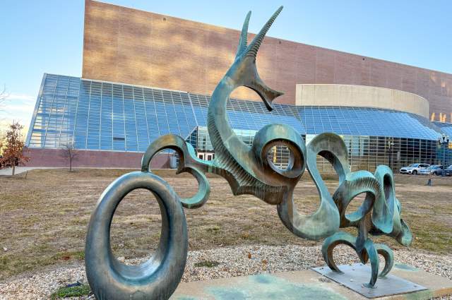 Cedric the Dragon sculpture by Nita Sunderland - Metal sculpture in outdoor plaza
