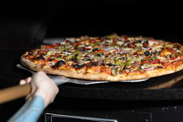 Hand stretched style and served by the slice!