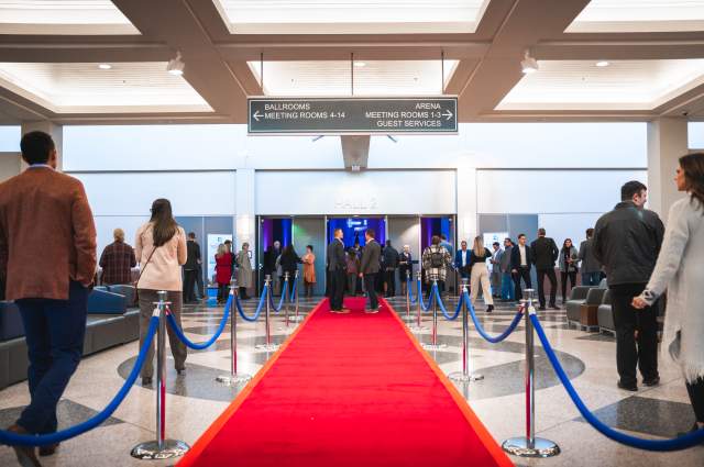 Red carpet entrance from the concourse hallway to the exhibit hall for a formal gathering