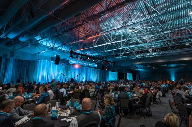 Room of Attendees Staring at a Stage for a Conference